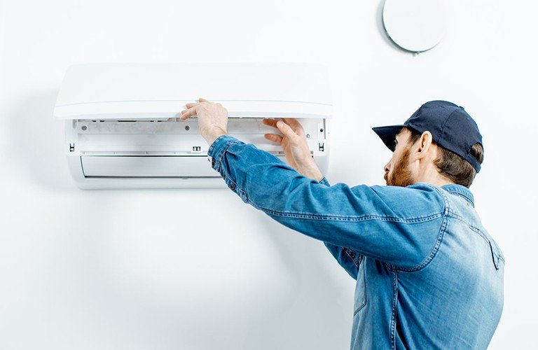 A man doing air conditioning maintenance in brisbane